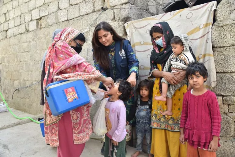 a who staff and a polio vaccinator during a vaccination campaign implemented in october 2025 in pakistan